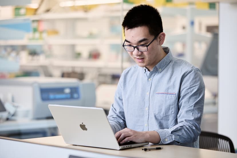 Professor Jingtian Zhou in lab with a scientist